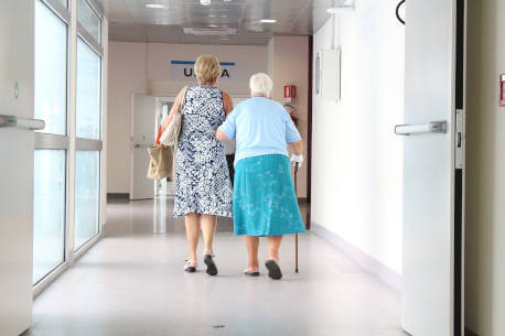 Elderly couple walking on cap and cove flooring